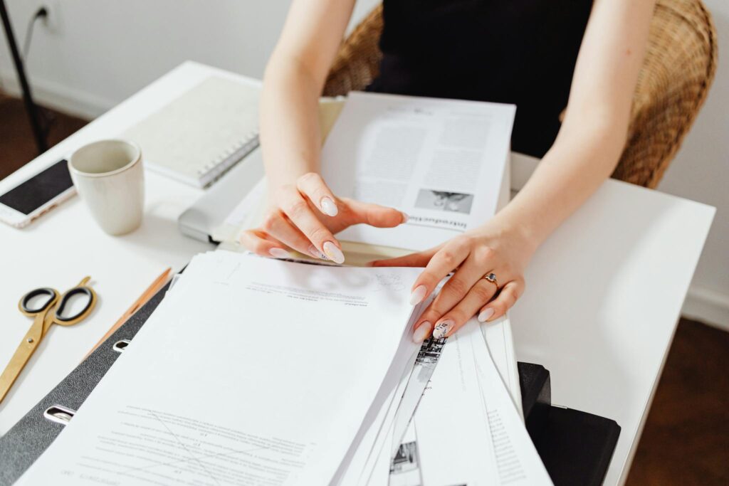 Close-Up Photo of Person Doing Paperwork